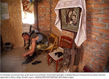 Ukrainian soldier in demolished church